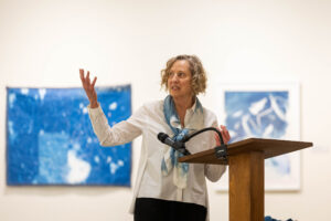 Ann Holsberry speaks to fellow alums about her Maier exhibit during Reunion