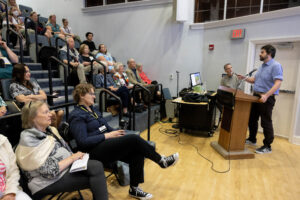 A group of people sitting in a lecture hall.