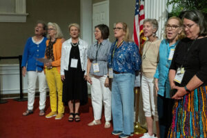 A group of alums sing together during an event