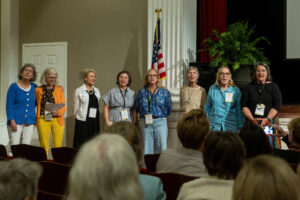 A group of alums sing together during an event