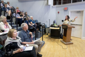 A group of people sitting in a lecture hall.