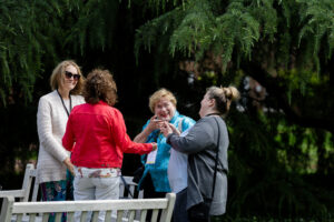 A group of alums talks and catches up around the Sundial