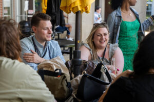 A table of alums sit and laugh together during Reunion