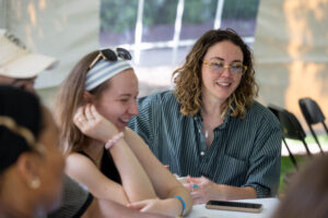 A table of alums sit and laugh together during Reunion