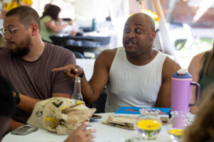 A table of alums sit and laugh together during Reunion