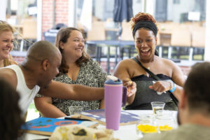 A table of alums sit and laugh together during Reunion