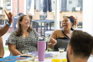 A table of alums sit and laugh together during Reunion