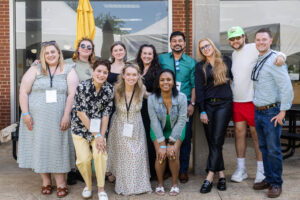 A group of alums pose for a photo together 