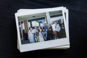 A photo of a stack of photos featuring alums 