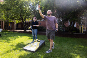 Two alums play a game of cornhole during Reunion
