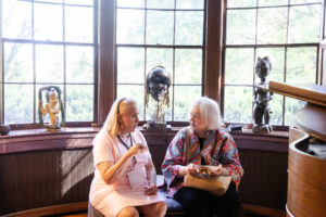 Two alums speak while sitting down inside Randolph House