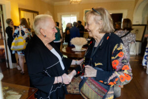 President Sue Ott Rowlands greets an alum at a reception in Randolph House 