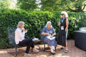 A group of three female alums talk together outside during Reunion