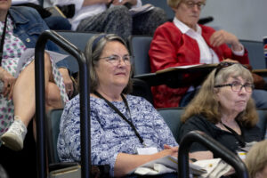 A group of people sitting in a lecture hall.