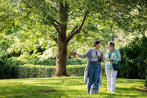 Two alums walk and talk to each other during Reunion