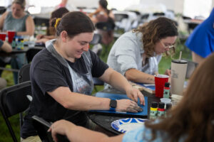 Alums participate in a Paint and Sip event during Reunion