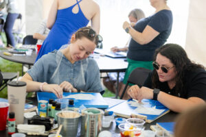 Alums participate in a Paint and Sip event during Reunion
