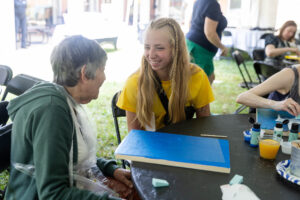 Alums participate in a Paint and Sip event during Reunion