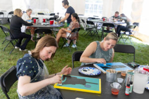 Alums participate in a Paint and Sip event during Reunion