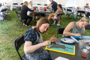 Alums participate in a Paint and Sip event during Reunion