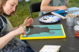 Alums participate in a Paint and Sip event during Reunion