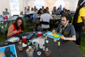 Alums participate in a Paint and Sip event during Reunion