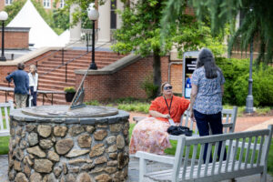 Two alums talk to each other by the Sundial