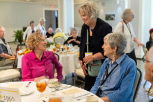 A group of women talking at a table.