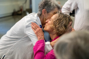 Two women hug during a Reunion event 