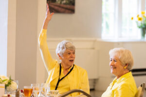 An alum raises her hand during a Reunion event 