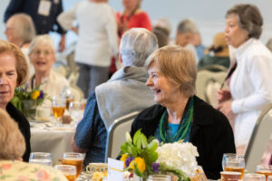 An alum sits at a table during a a Reunion event 