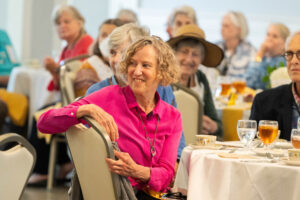 An alum sits at a table during a a Reunion event 