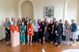 A group of women standing together in a room.