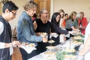A group of people in line to get food during a Reunion event