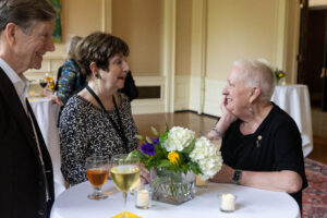 President Sue Ott Rowlands speaks to an alum during a Reunion event 