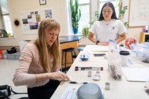 Two women working on a project in a classroom.