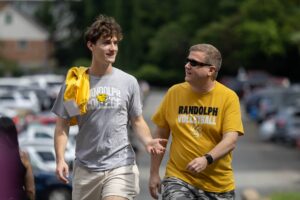 Two men walk together in Randolph College gear