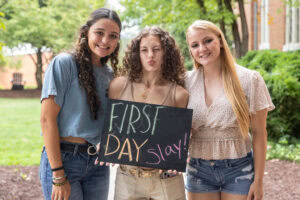 Student pose together with a sign that says "First Day Slay"