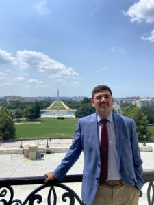 A man stands with the National Mall in the background 