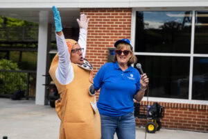 A man in a Mr. Potato Head suit holds his arms in the air