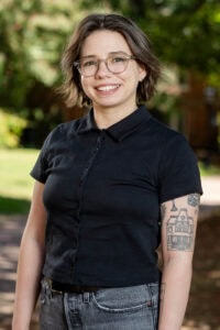 A professor poses for a photo on front campus 