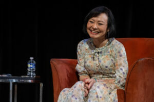 Kim Phuc Phan Thi smiles from the stage, telling her story.