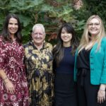 Four women post together for a photo