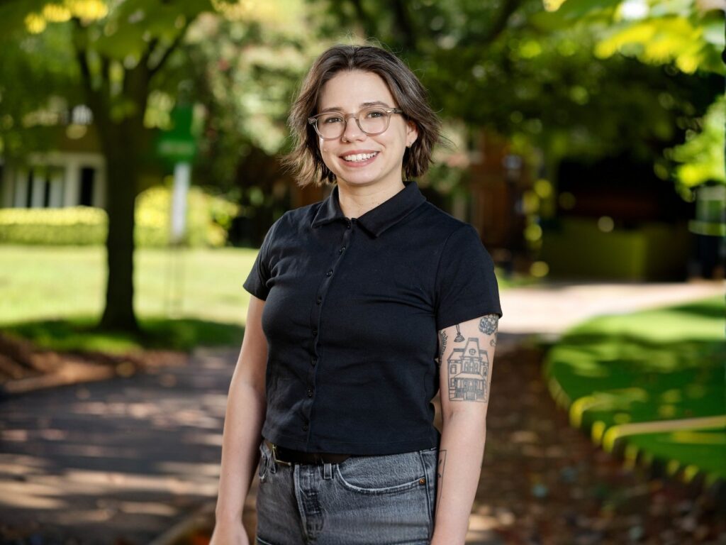 A professor poses for a photo on front campus