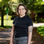 A professor poses for a photo on front campus