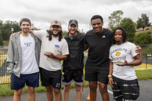 A group of men poses for a photo together during an event