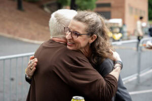 Two women hug 