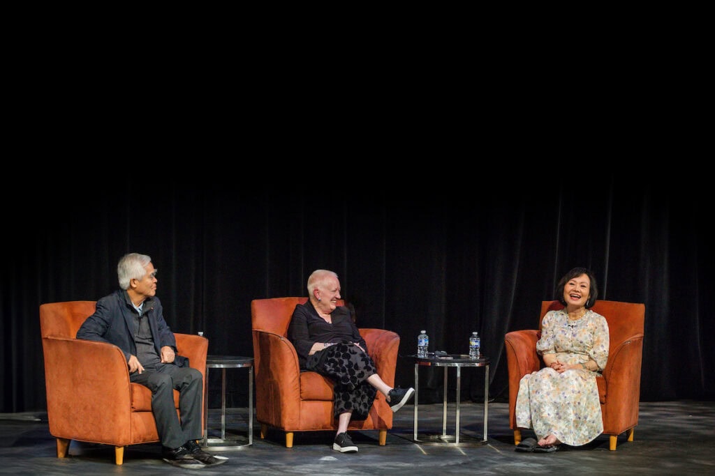 Nick Ut, Sue Ott Rowlands, and Kim Phuc Phan Thi sit on the stage in Thoresen Theatre during a special Q&A
