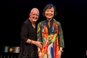 President Sue Ott Rowlands poses with Kim Phuc Phan Thi for a photo