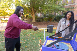 A student plays a game during a fall festival